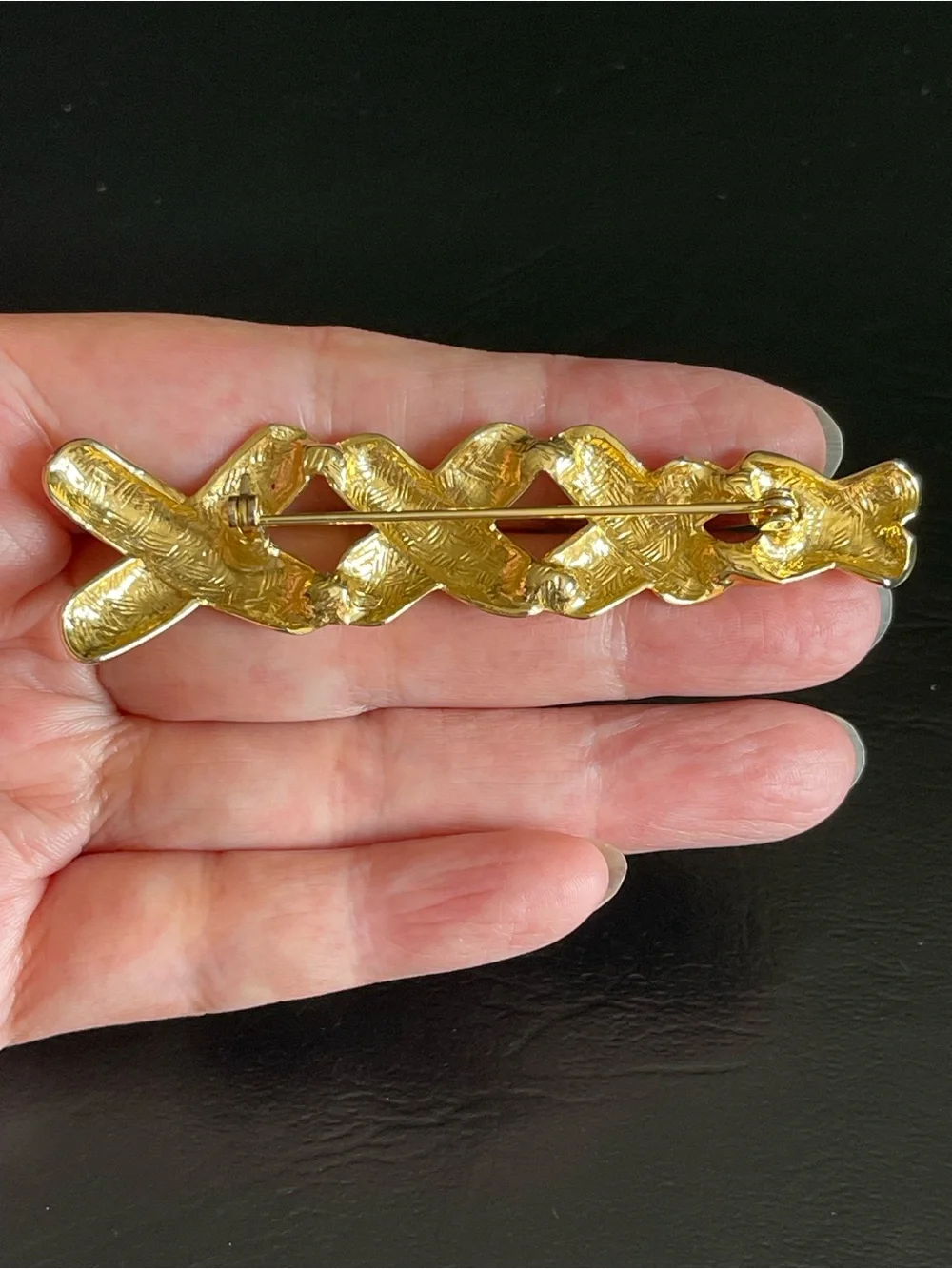 Vintage gold tone xxxx brooch.
